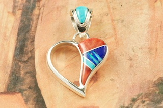 Genuine Spiny Oyster Shell, Turquoise  and Blue Lapis inlaid between ribbons of  Sterling Silver with Fire and Ice Lab Opal Accents. Free 18" Sterling Silver Chain with Purchase of Pendant. Beautiful Heart Pendant Designed by Navajo Artist Calvin Begay. Signed.